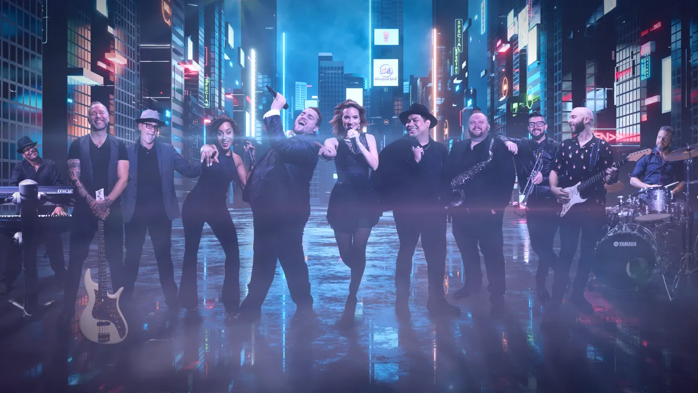 The uRequest Live band lined up on a neon-lit city street